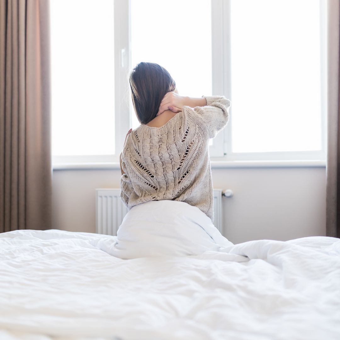 woman in bed with sore neck