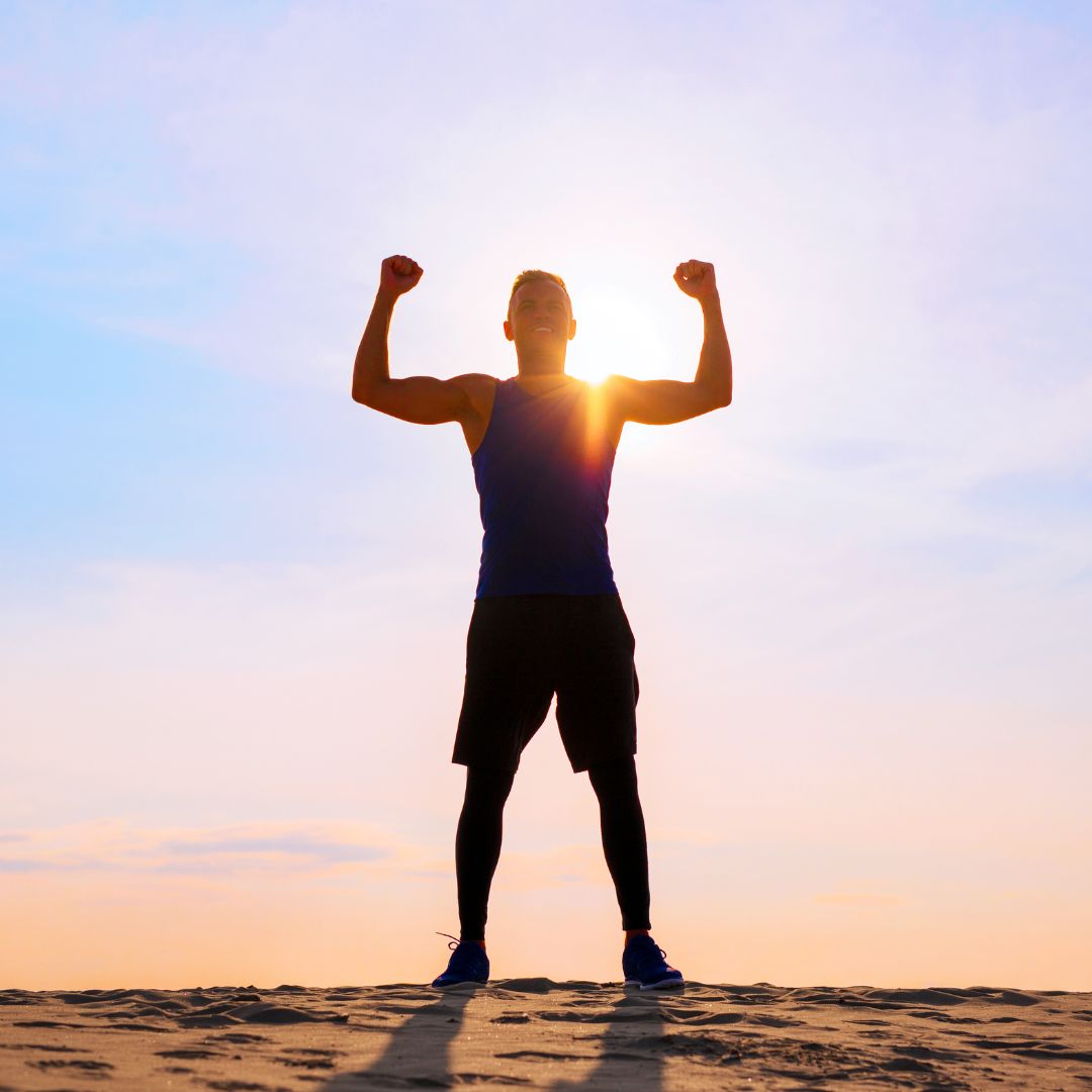 man outside with hands in air