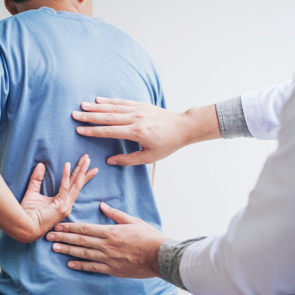 patient showing doctor where his back hurts