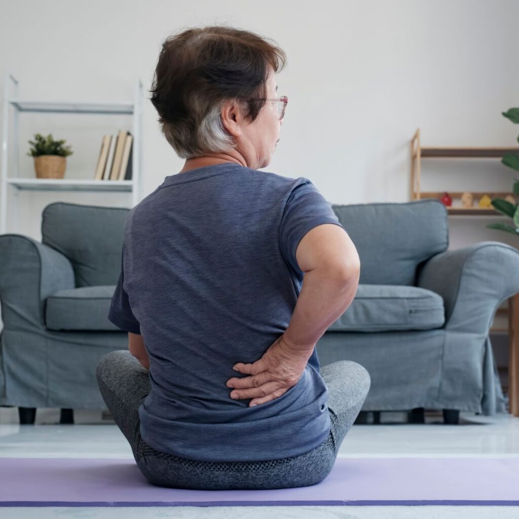 stretching back on floor, sitting up, in some pain